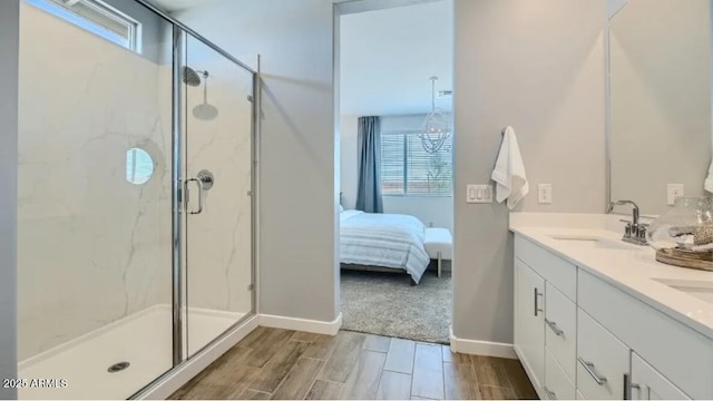 922 W Peralta Pass, Apache Junction, AZ 85120 - ensuite bathroom with a marble finish shower, double vanity, healthy amount of natural light, and wood finish floors