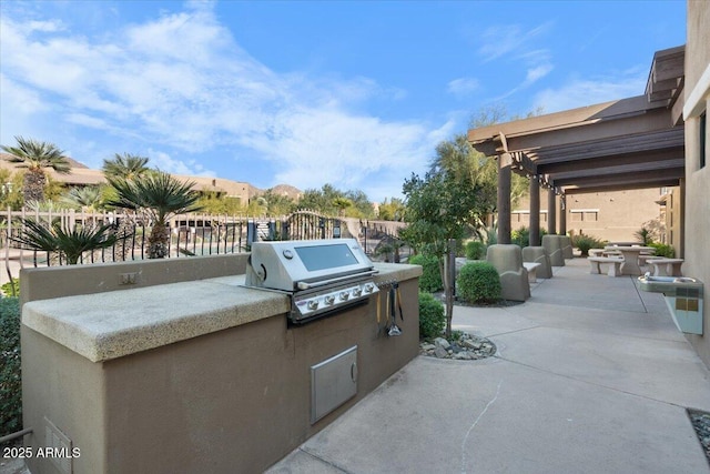 view of patio with a mountain view, exterior kitchen, and grilling area