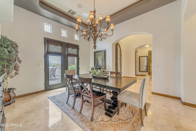 3217 N Piedra Cir, Mesa, AZ 85207 - dining room featuring arched walkways, plenty of natural light, a chandelier, and light tile patterned flooring