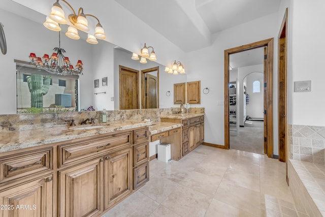 3217 N Piedra Cir, Mesa, AZ 85207 - full bathroom featuring a chandelier, vanity, tile patterned flooring, and baseboards