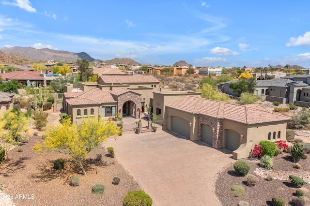3217 N Piedra Cir, Mesa, AZ 85207 - mediterranean / spanish house featuring stucco siding, a residential view, a garage, and driveway