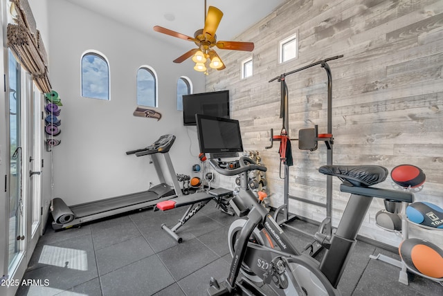 3217 N Piedra Cir, Mesa, AZ 85207 - workout area featuring wood walls, plenty of natural light, a ceiling fan, and a towering ceiling