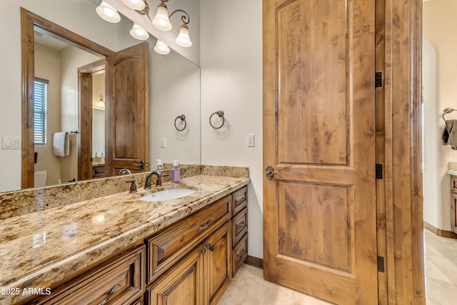 3217 N Piedra Cir, Mesa, AZ 85207 - bathroom with tile patterned floors, vanity, baseboards, and toilet