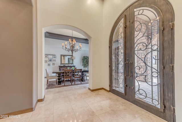 3217 N Piedra Cir, Mesa, AZ 85207 - entrance foyer featuring french doors, arched walkways, a chandelier, and baseboards