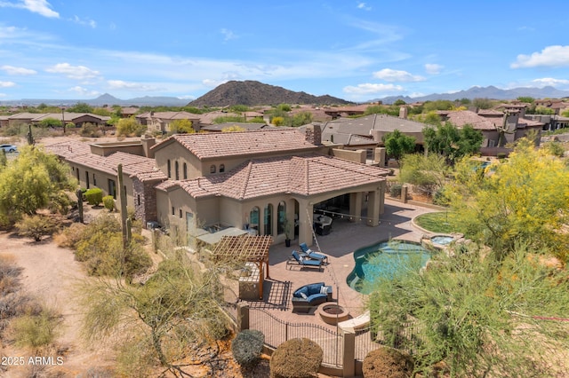 3217 N Piedra Cir, Mesa, AZ 85207 - rear view of house featuring an outdoor fire pit, stucco siding, a patio, and a residential view