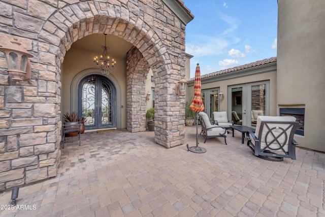 3217 N Piedra Cir, Mesa, AZ 85207 - entrance to property featuring french doors, stone siding, and a patio area