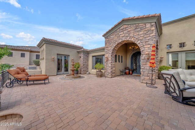 3217 N Piedra Cir, Mesa, AZ 85207 - rear view of property featuring french doors, stucco siding, a patio, and a tile roof