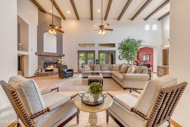 3217 N Piedra Cir, Mesa, AZ 85207 - living room with beamed ceiling, a stone fireplace, a high ceiling, ceiling fan, and recessed lighting