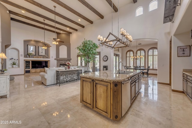 3217 N Piedra Cir, Mesa, AZ 85207 - kitchen with a sink, a chandelier, a fireplace, beam ceiling, and ceiling fan