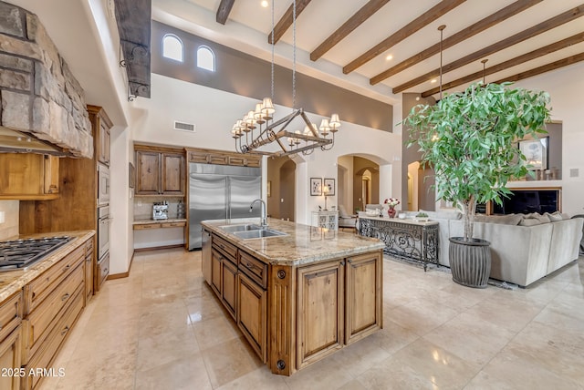 3217 N Piedra Cir, Mesa, AZ 85207 - kitchen with built in appliances, a sink, arched walkways, a towering ceiling, and beamed ceiling