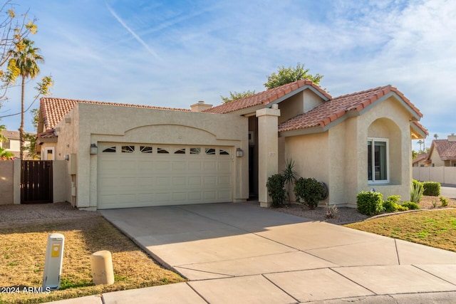 mediterranean / spanish home featuring a garage