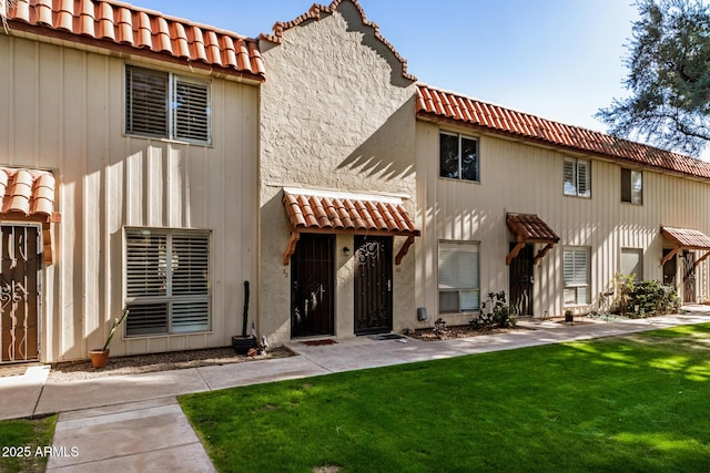 back of property featuring a lawn