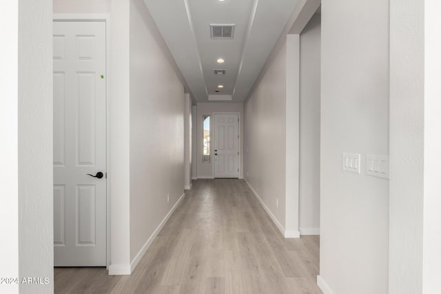 corridor with light hardwood / wood-style floors