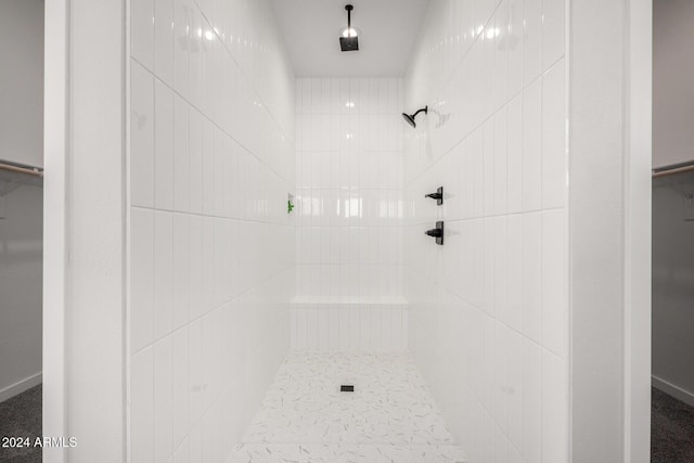 bathroom with a tile shower