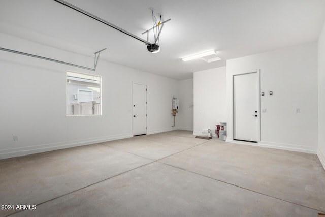 garage with a garage door opener and water heater