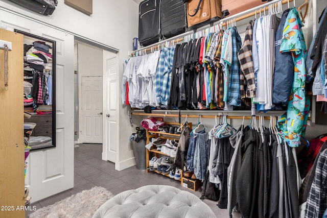 walk in closet with tile patterned flooring