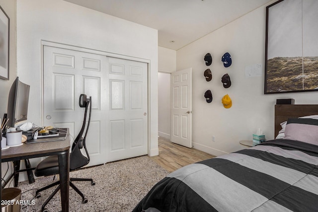 bedroom with a closet and light hardwood / wood-style flooring