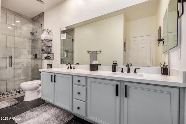 bathroom featuring an enclosed shower, vanity, tile patterned floors, and toilet