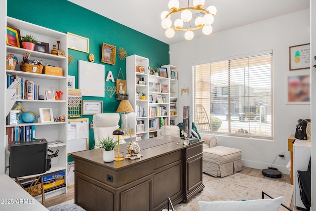 office with a notable chandelier, a healthy amount of sunlight, and light wood-type flooring