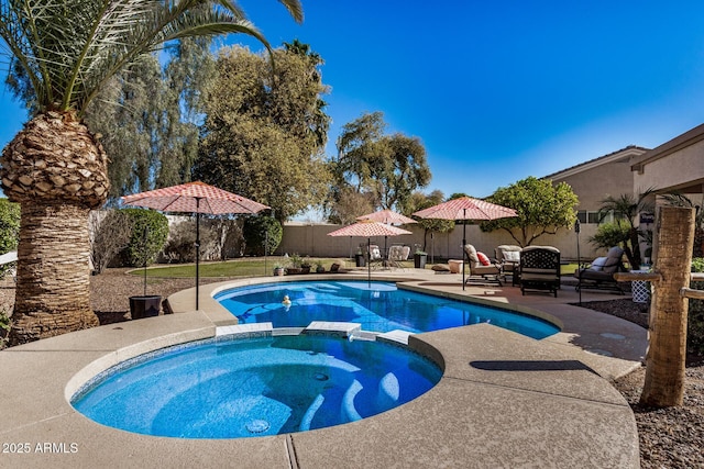 view of swimming pool featuring an in ground hot tub and a patio area