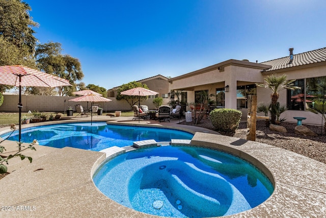 view of pool with an in ground hot tub and a patio area