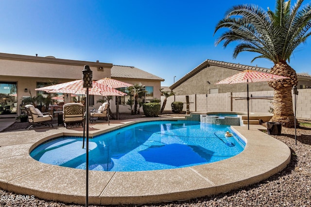 view of swimming pool with a patio area and an in ground hot tub