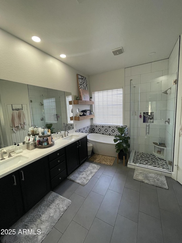 bathroom featuring vanity and shower with separate bathtub