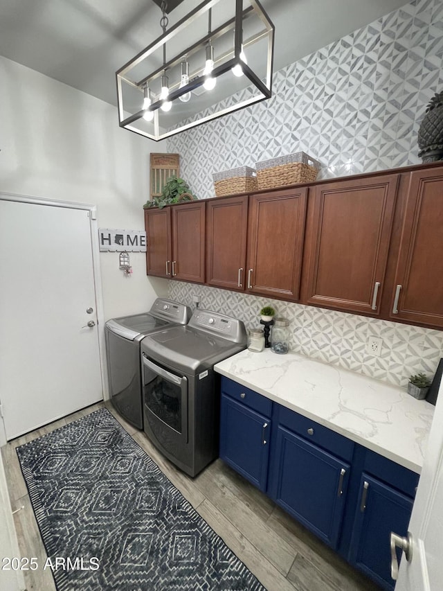 laundry room with cabinets and washer and dryer