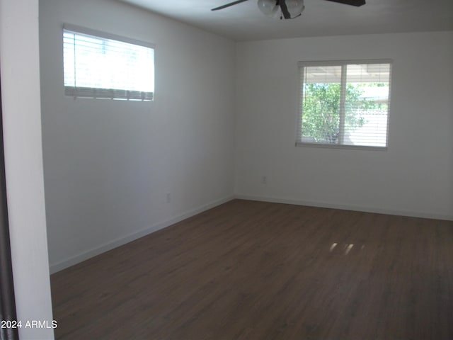 empty room featuring ceiling fan and dark hardwood / wood-style flooring