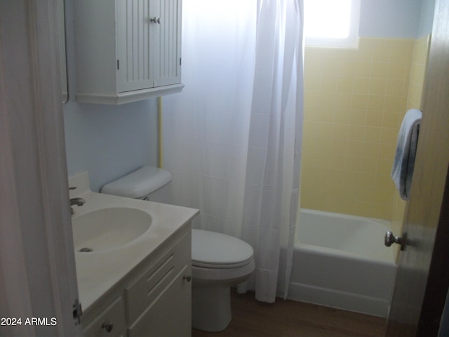 full bathroom featuring vanity, toilet, hardwood / wood-style floors, and shower / bath combo with shower curtain