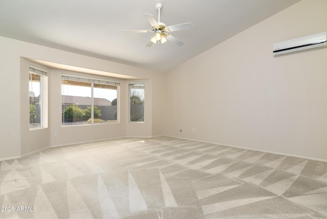 spare room with vaulted ceiling, light carpet, and a wall mounted AC