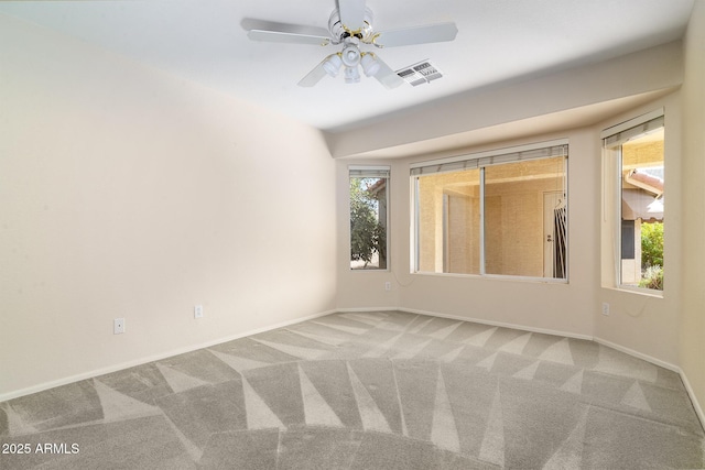 carpeted spare room with ceiling fan