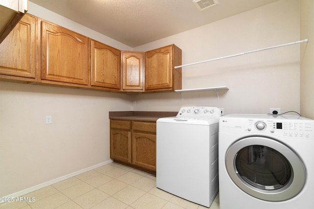 laundry area featuring independent washer and dryer and cabinets