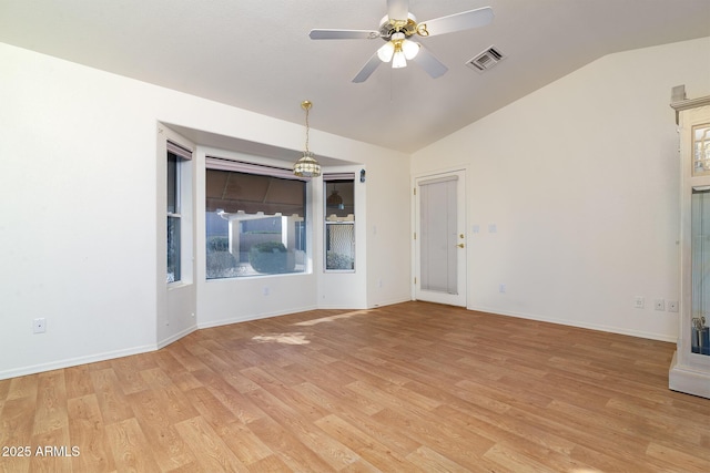 spare room with lofted ceiling, light hardwood / wood-style floors, and ceiling fan