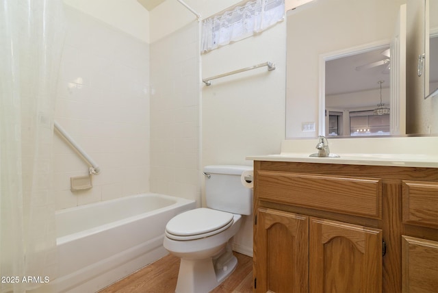 full bathroom with vanity, hardwood / wood-style floors, toilet, and washtub / shower combination