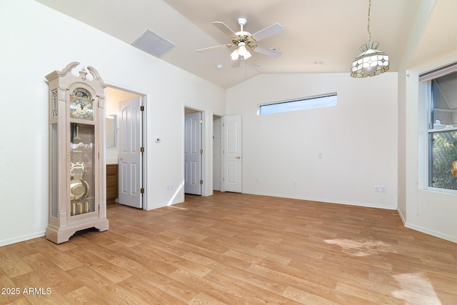 unfurnished room featuring vaulted ceiling, plenty of natural light, ceiling fan, and light hardwood / wood-style floors