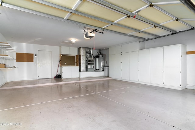 garage featuring a garage door opener and water heater