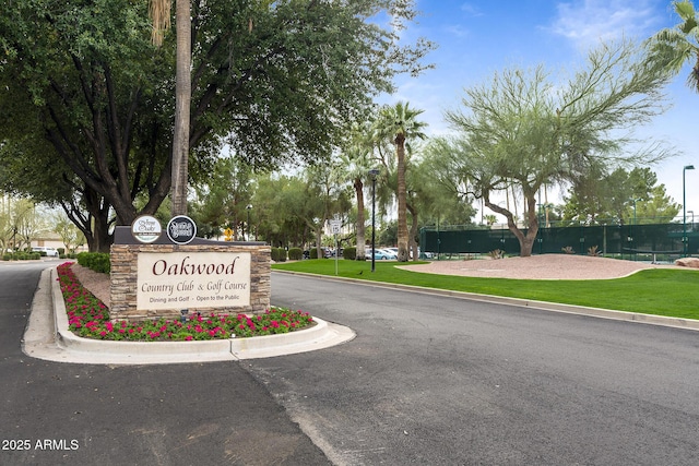 community sign featuring a yard