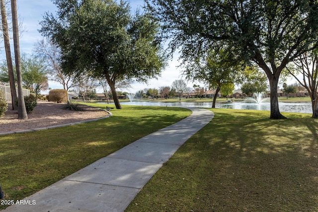 view of property's community featuring a water view and a yard