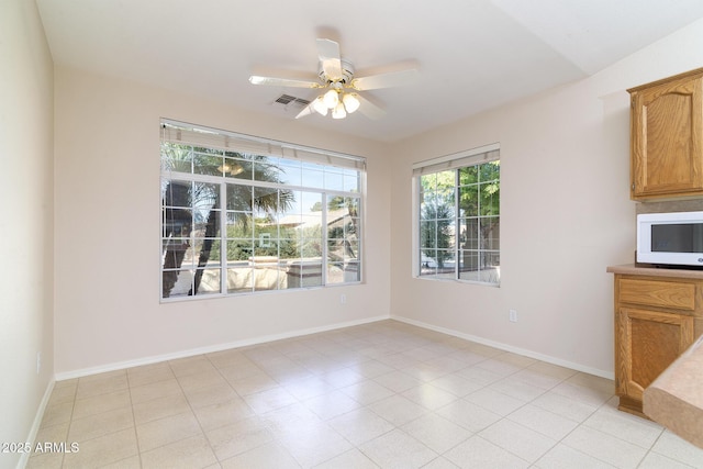 unfurnished dining area featuring ceiling fan and vaulted ceiling