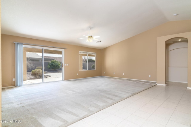 carpeted empty room featuring vaulted ceiling and ceiling fan