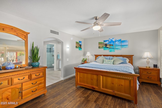 bedroom with ceiling fan, dark hardwood / wood-style floors, and ensuite bath