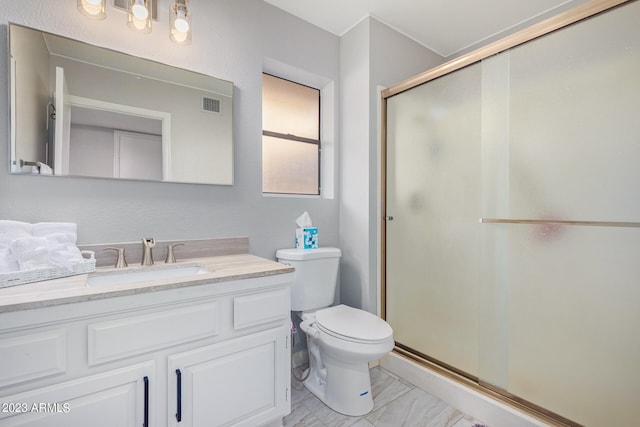 bathroom with toilet, an enclosed shower, and vanity