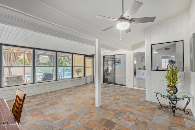 unfurnished sunroom with ceiling fan