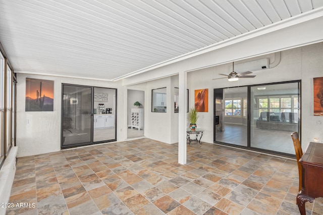 interior space with ceiling fan