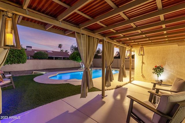 pool at dusk with a patio