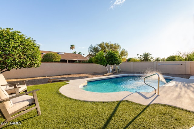 view of swimming pool featuring a patio area and a yard