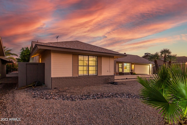 view of back house at dusk