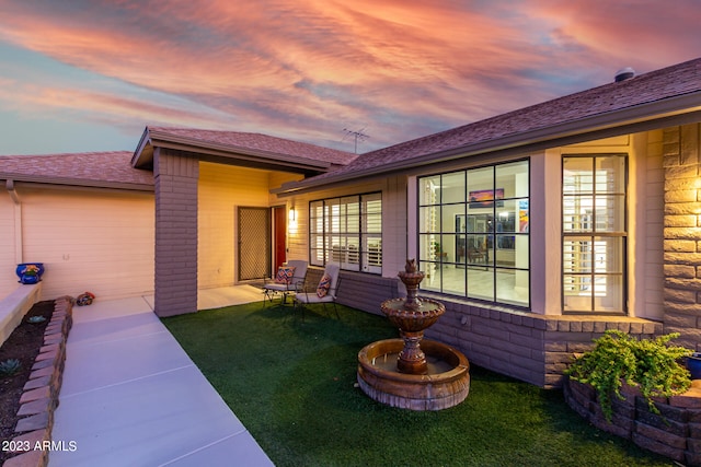 exterior space featuring a lawn and a patio