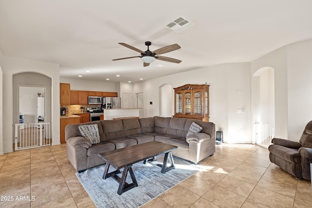 living room with light tile patterned floors and ceiling fan